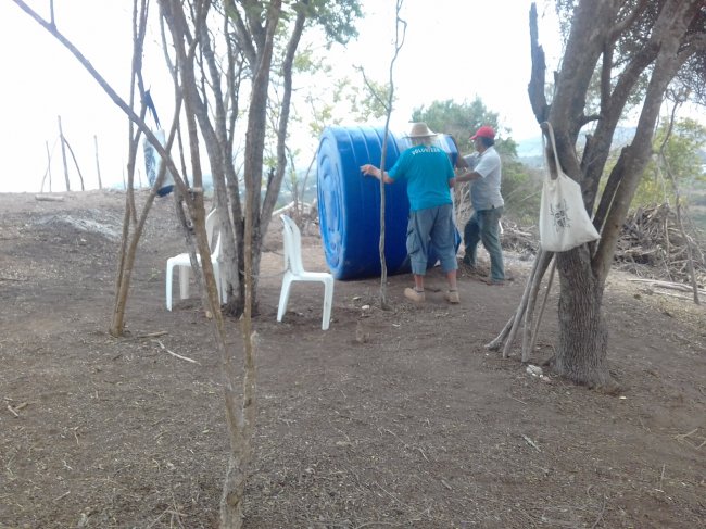 Rolling water tank to top of hill